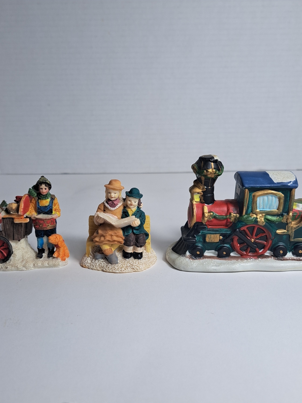 3 Unbranded Christmas Figurines, "The Vendor", The Readers", "Christmas Train"